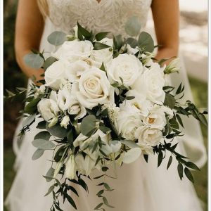 A graceful mix of white peonies and roses, wrapped in satin ribbon